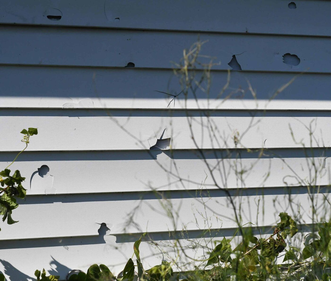 Why home resilience is important: Garage siding has large holes in it caused by 2-inch hail, southeast Wisconsin.